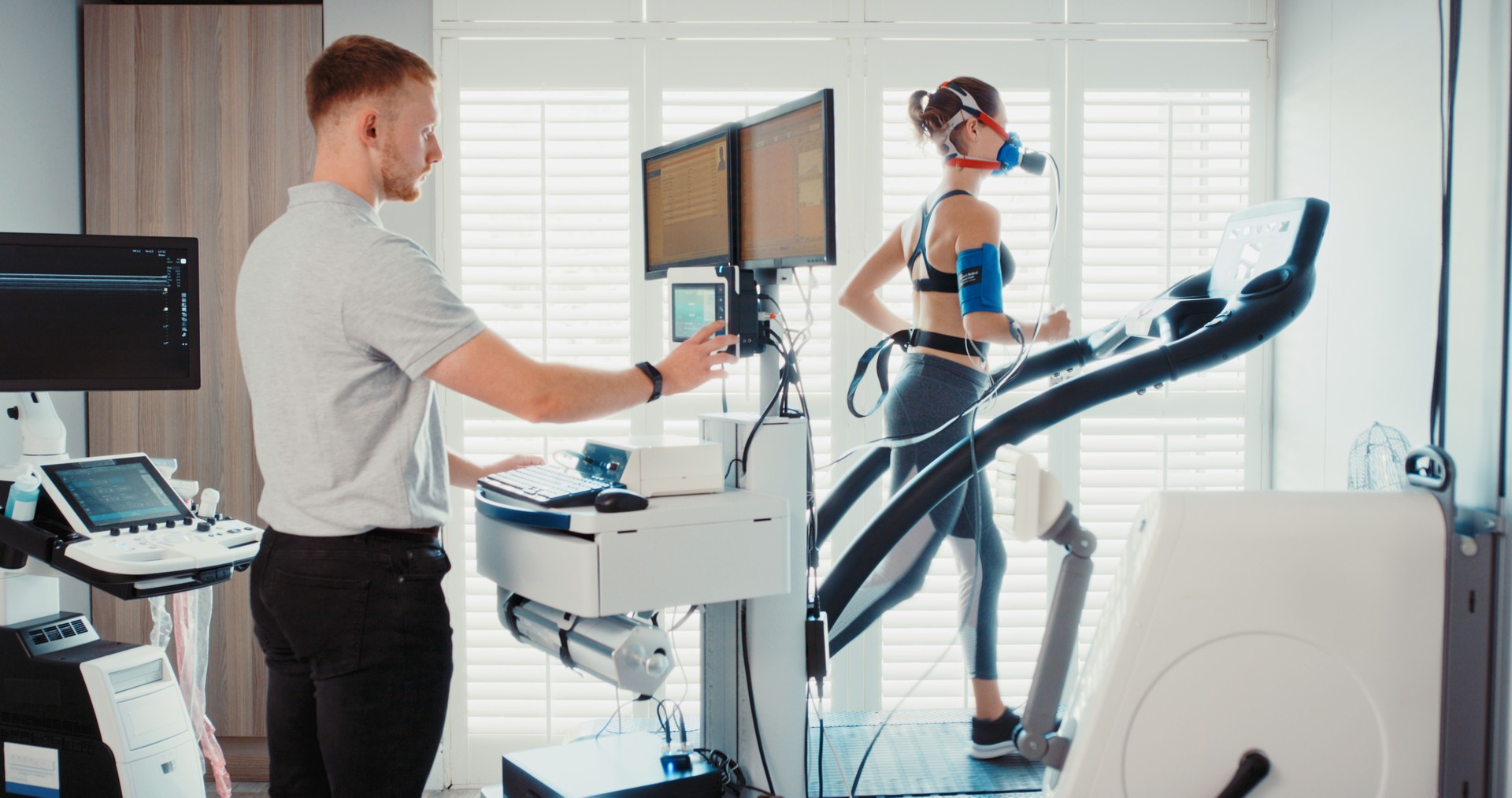 Medical sports doctor doing research on woman athlete, analysis on fitness health and training breathing at sports clinic. Person running on treadmill for science and evaluation on lung at lab